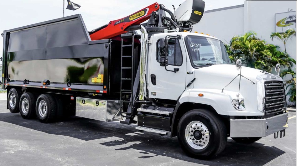 Rick's 57-Yard Grapple Truck with a white cab, black debris body and red loading crane for dumpster-alternative debris pickup
